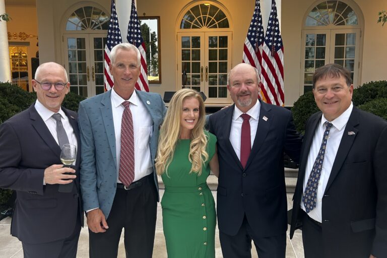 ORR White House Rose Garden Dinner Five people in suits pose outside of the Oval Office in Washington, D.C.