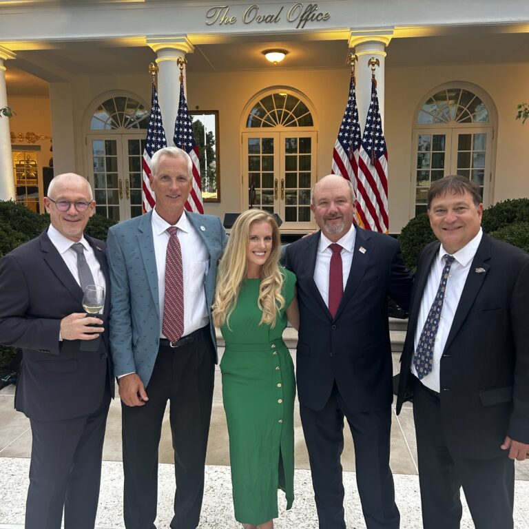 ORR White House Rose Garden Dinner Five people in suits pose outside of the Oval Office in Washington, D.C.