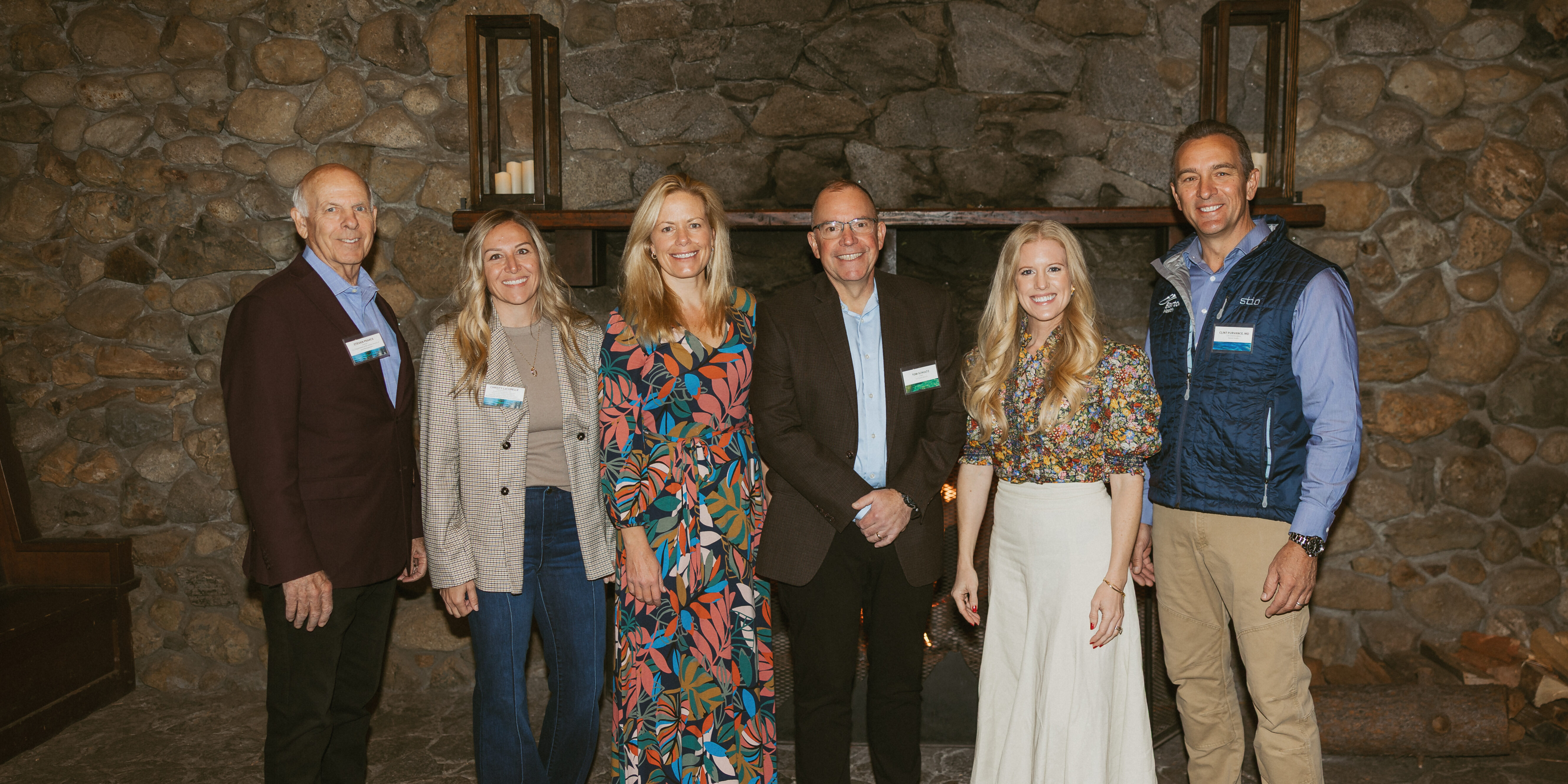 ORR x Barton Health Six professionals, including members of the Administration, stand in front of a fire place in Valhalla Tahoe.